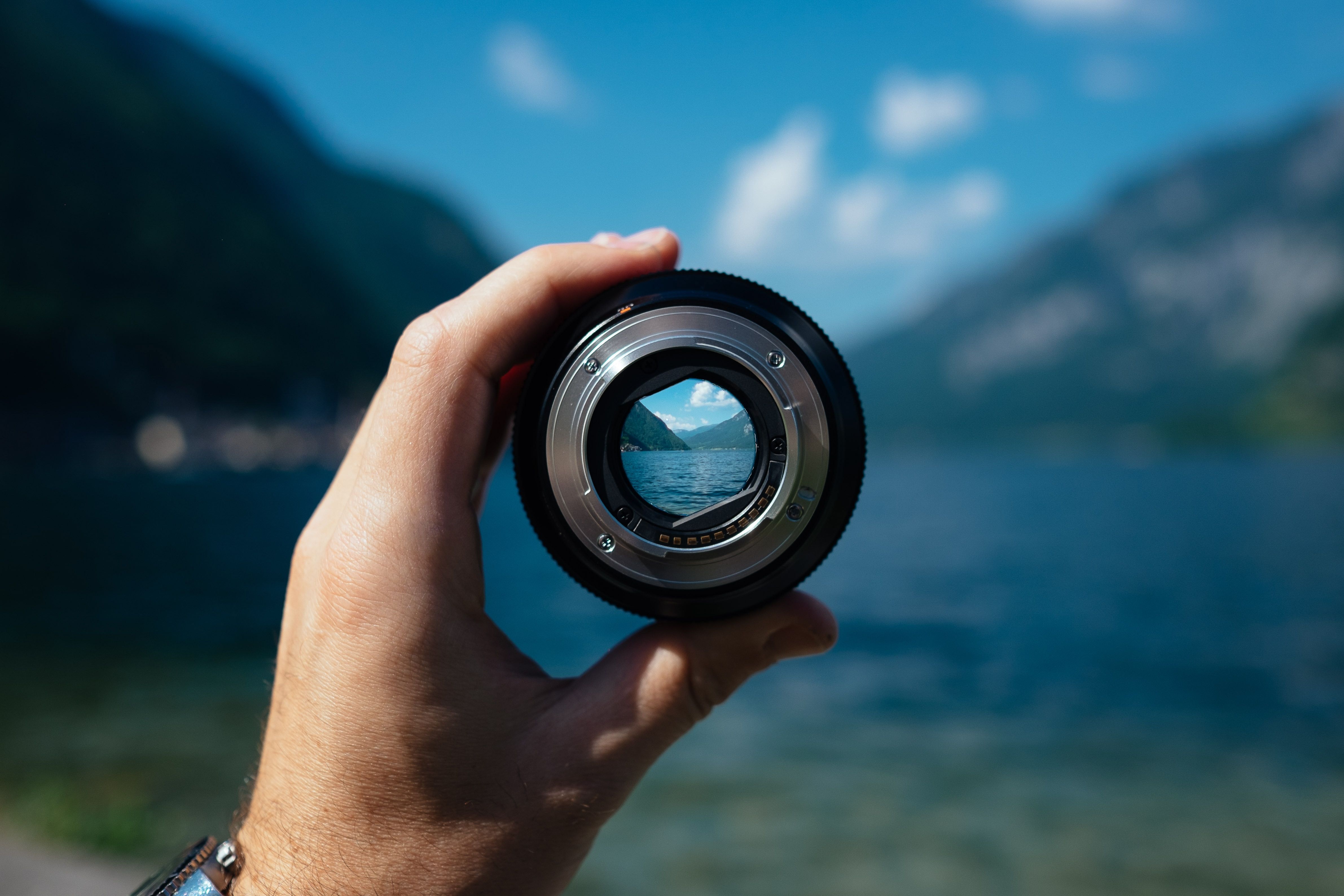 An image of a person looking through a magnification lens at a mountain in the distance