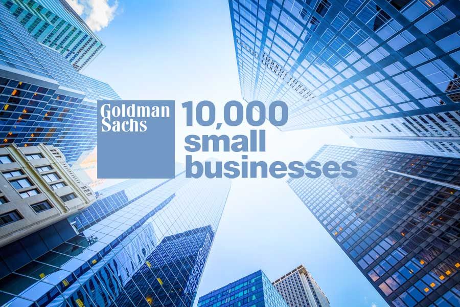 Image of the Goldman Sachs 10,000 Small Businesses logo superimposed on a from-the-ground-up photo looking up through NYC skyscrapers