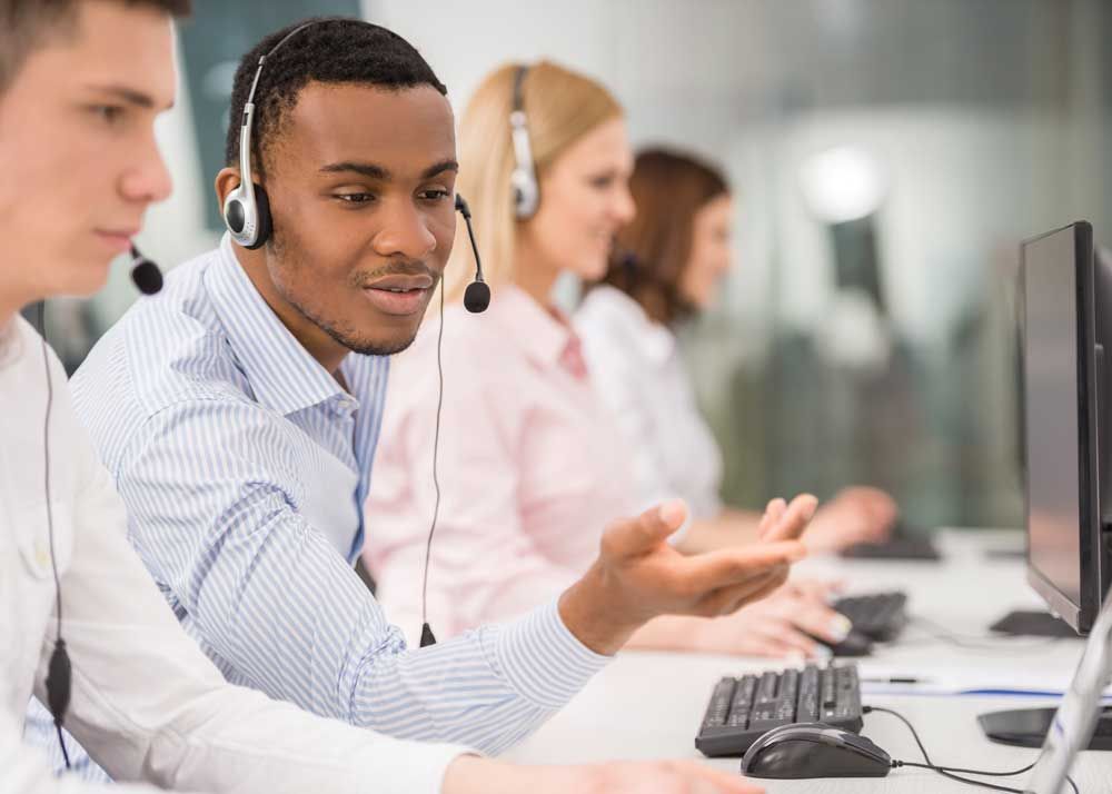An image of several people working in a call center