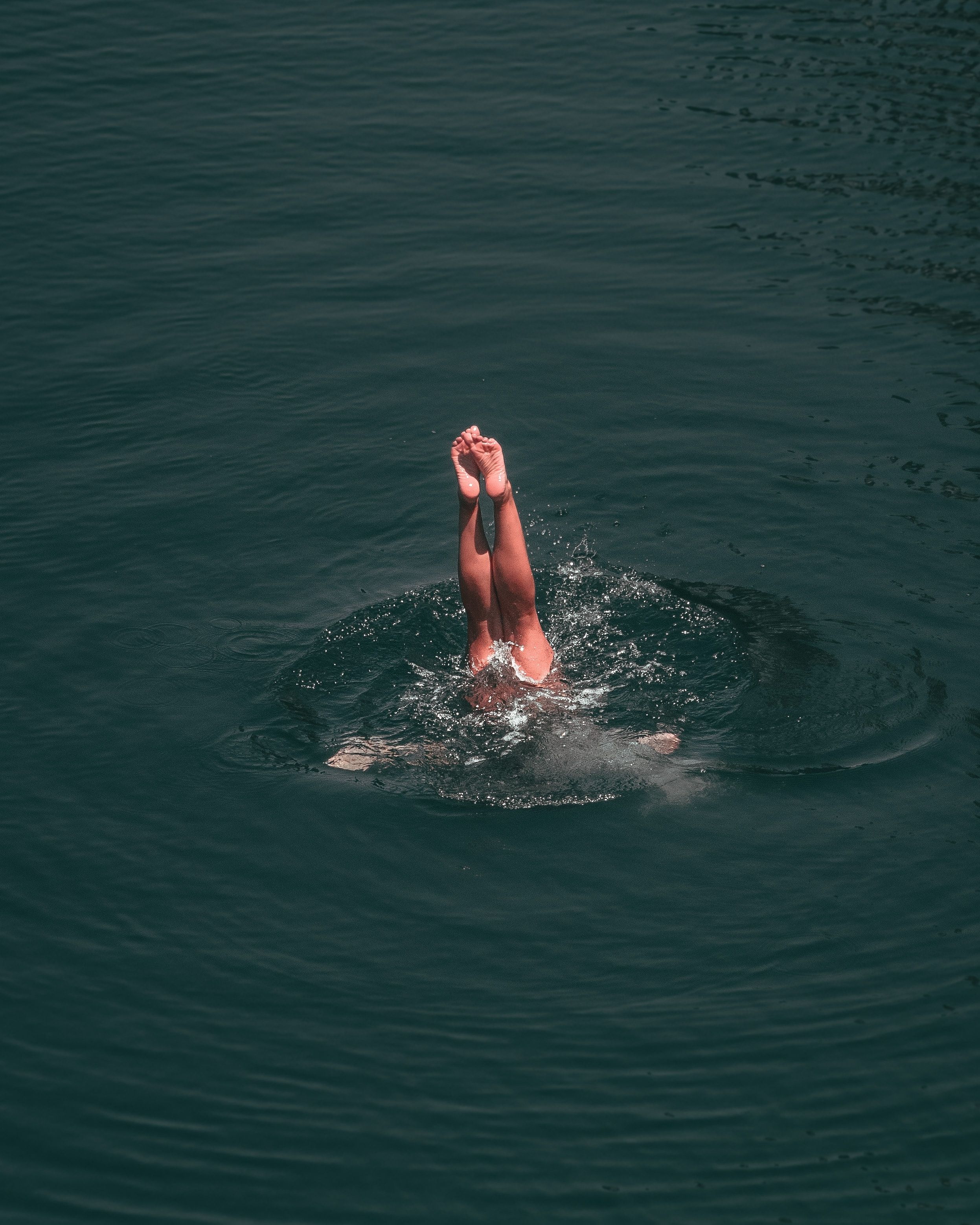 Am image of a young woman diving into a lake