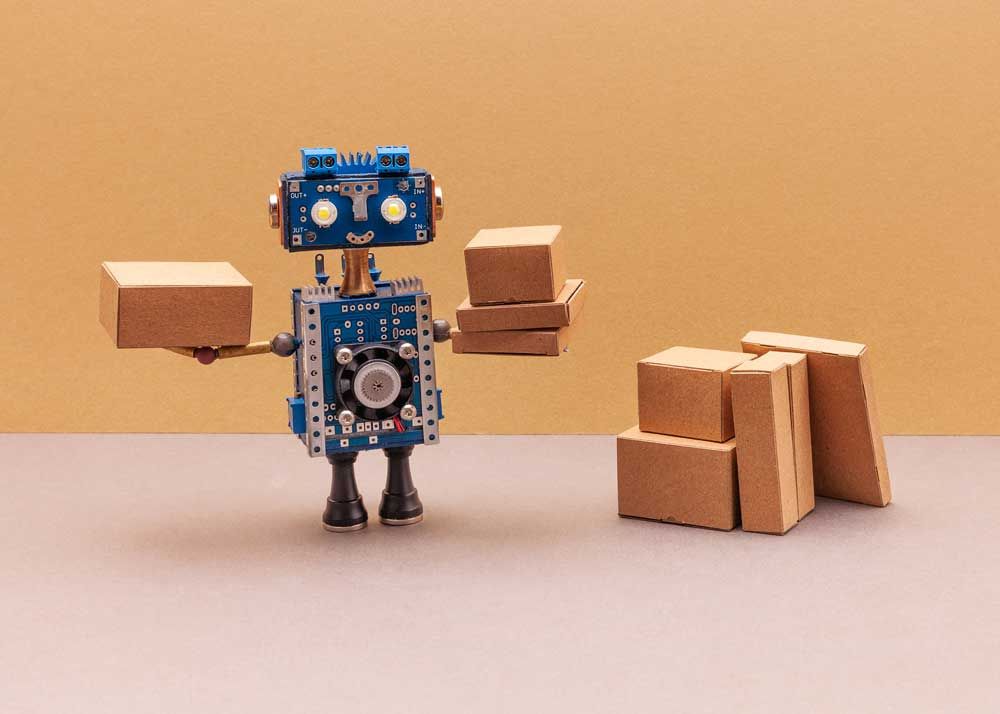 Image of tiny robot holding boxes.