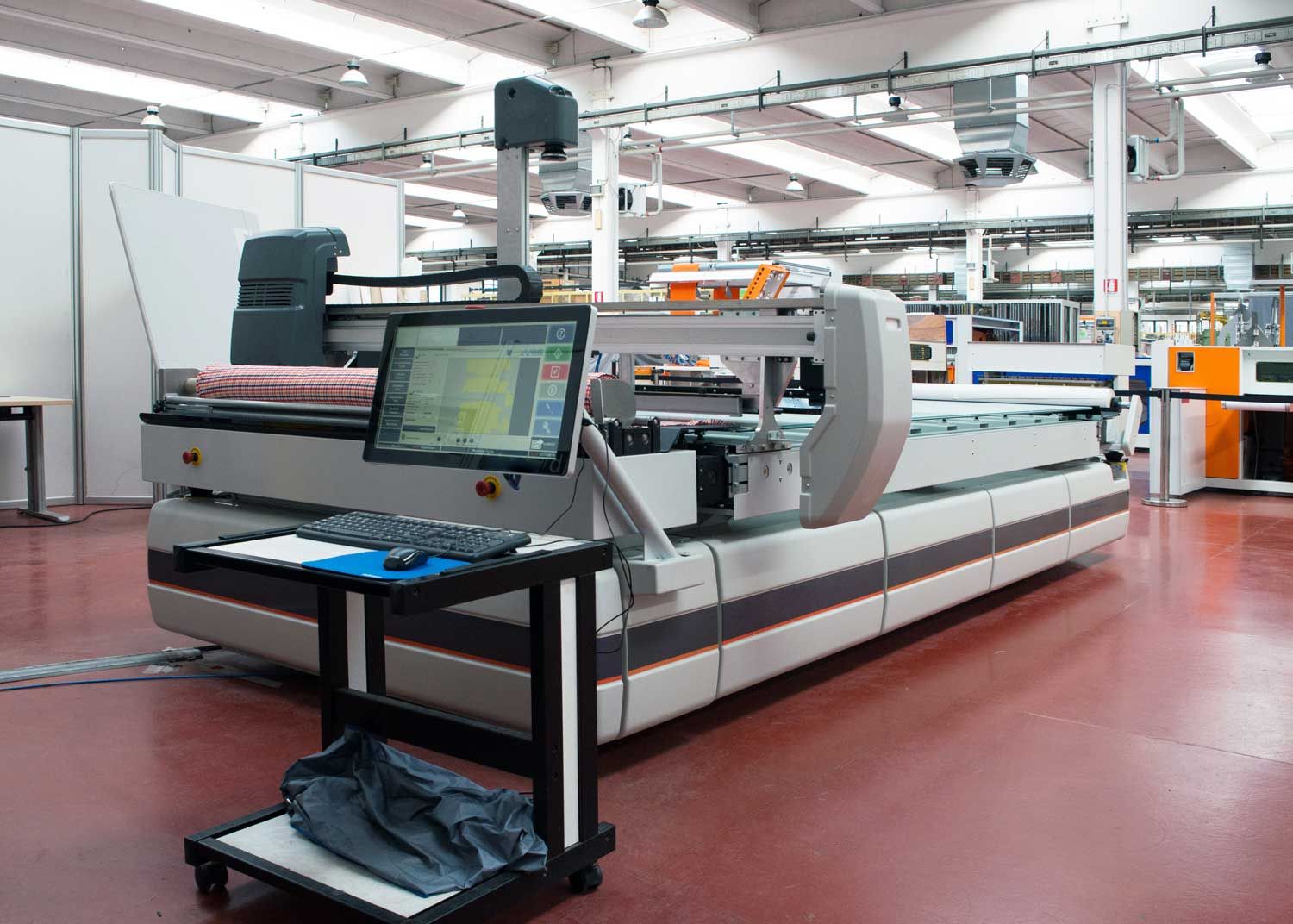 Image of an industrial laser cutting machine for fabric